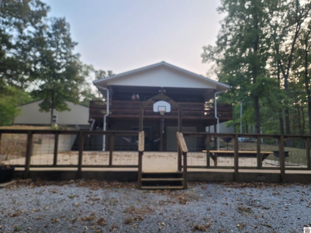 back of property featuring a wooden deck