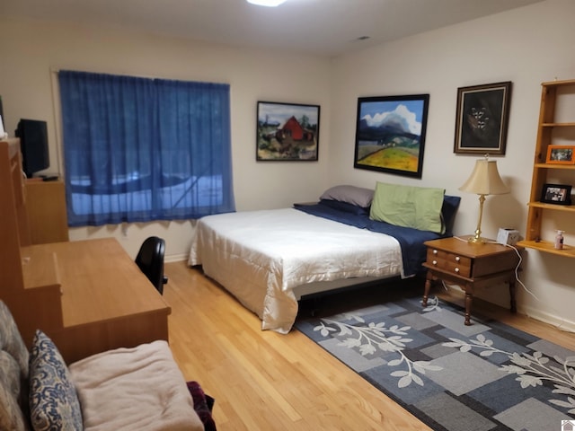 bedroom with hardwood / wood-style flooring