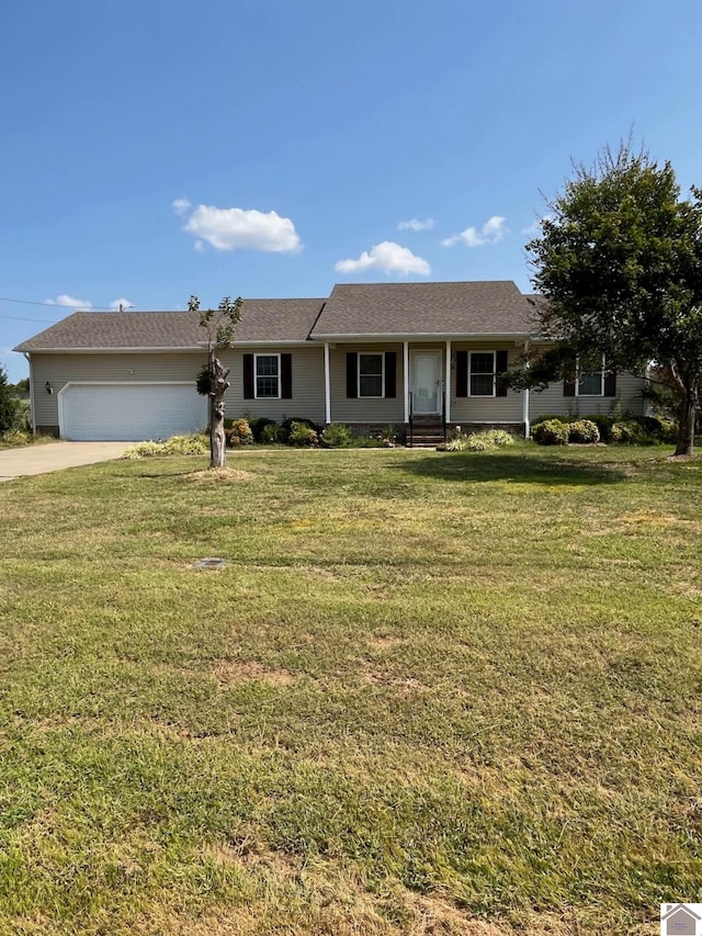 ranch-style home featuring a front lawn and a garage