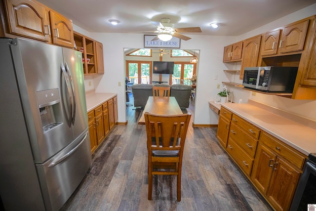 kitchen featuring dark wood-type flooring, stainless steel appliances, and ceiling fan