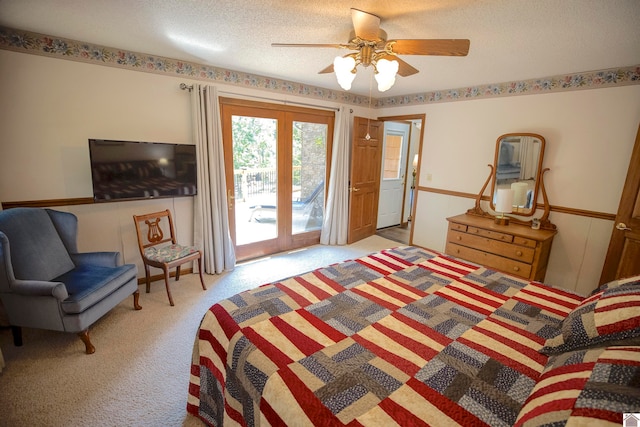 carpeted bedroom with french doors, ceiling fan, access to exterior, and a textured ceiling