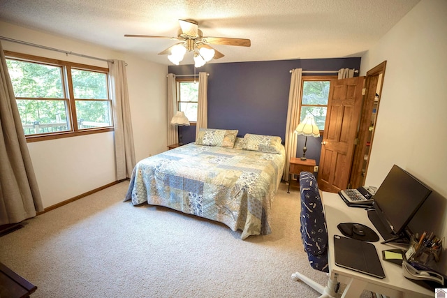 bedroom featuring a textured ceiling, carpet flooring, and ceiling fan