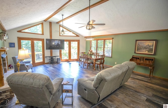 living area featuring wood finished floors, a textured ceiling, lofted ceiling with beams, and ceiling fan