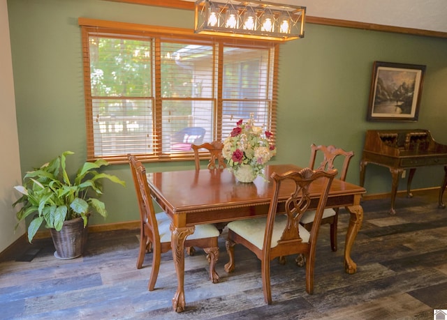 dining room with baseboards, wood finished floors, and a healthy amount of sunlight
