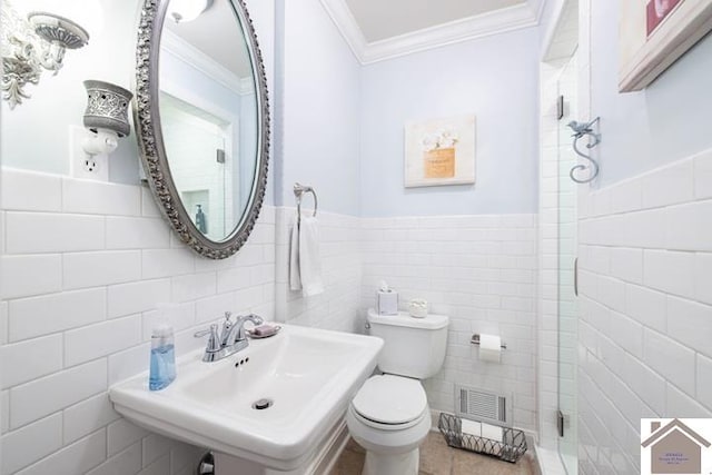 bathroom featuring ornamental molding, sink, tile walls, and toilet