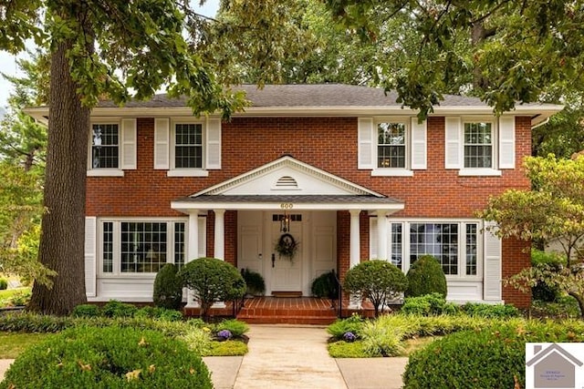 colonial home featuring covered porch