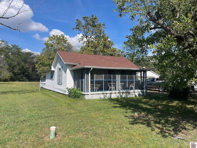 view of front facade featuring a sunroom and a front yard