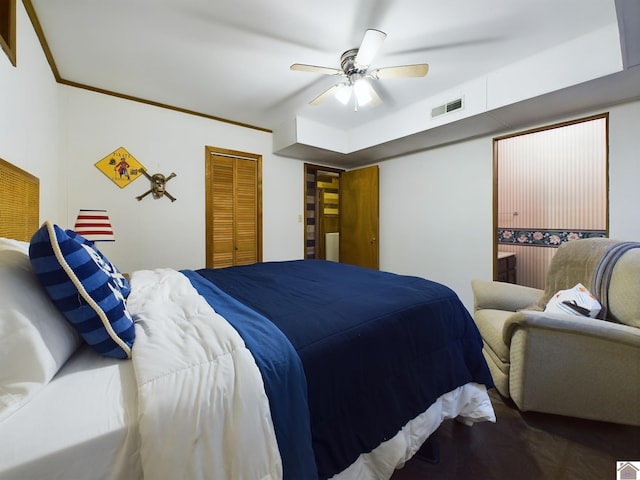 bedroom featuring ceiling fan, a closet, crown molding, and wood-type flooring