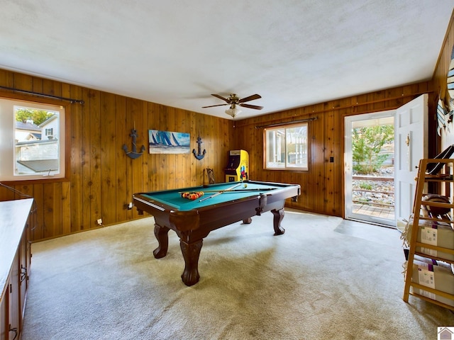 game room with pool table, wood walls, ceiling fan, and a wealth of natural light