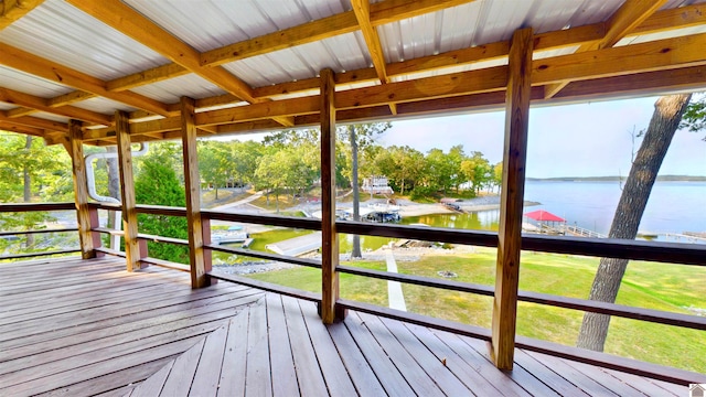 unfurnished sunroom with a water view