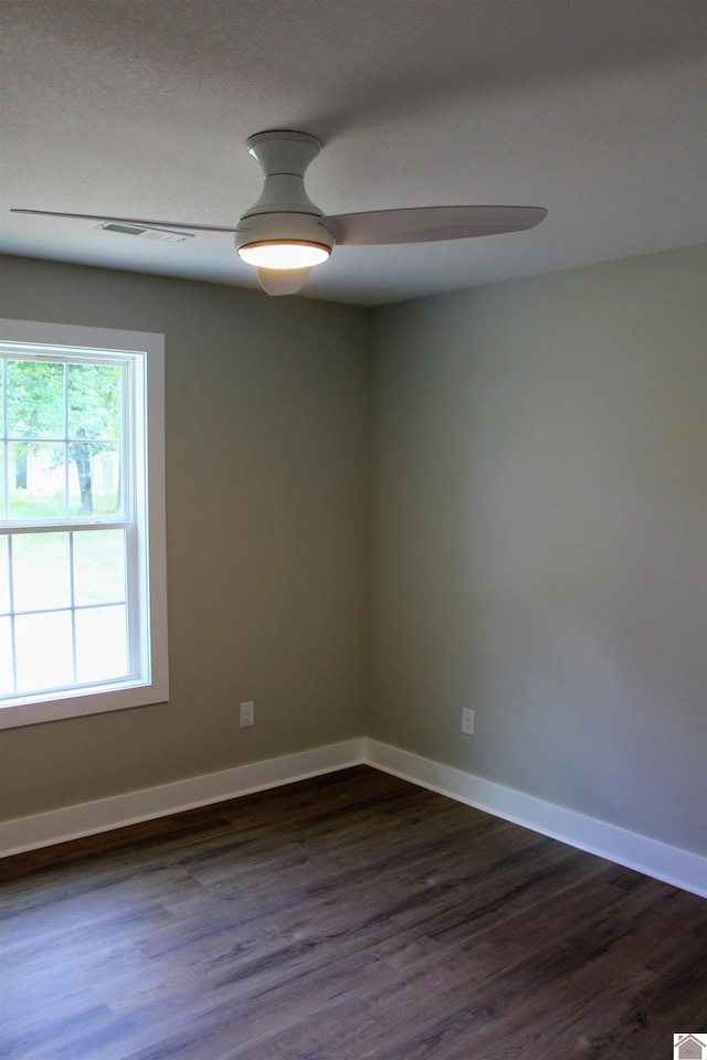 spare room featuring ceiling fan and dark hardwood / wood-style floors