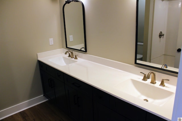 bathroom featuring vanity, toilet, and wood-type flooring