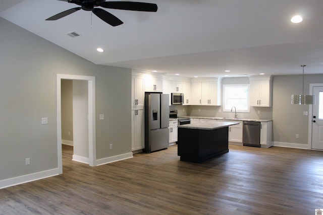 kitchen with sink, a center island, hanging light fixtures, stainless steel appliances, and white cabinets