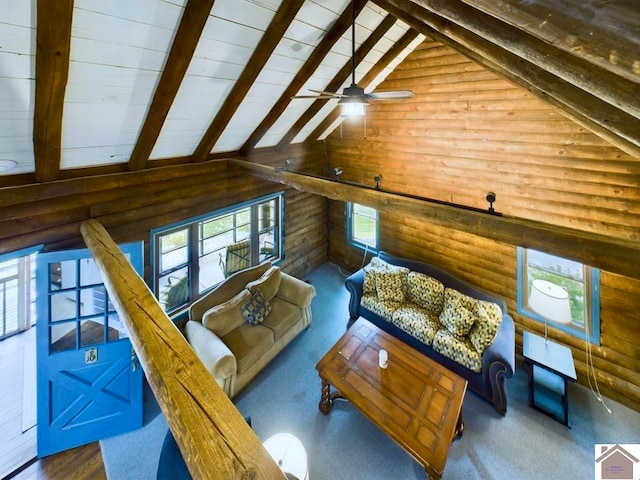 living room with ceiling fan, vaulted ceiling with beams, wood walls, log walls, and hardwood / wood-style flooring