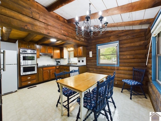 dining space featuring wood ceiling, a chandelier, sink, beam ceiling, and rustic walls