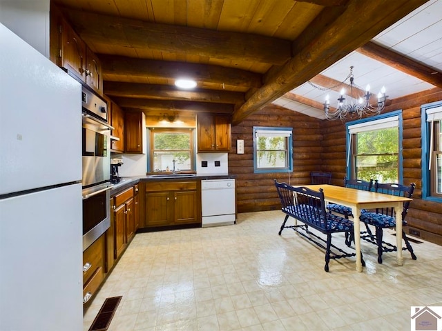 kitchen with vaulted ceiling with beams, wood ceiling, white appliances, rustic walls, and a chandelier