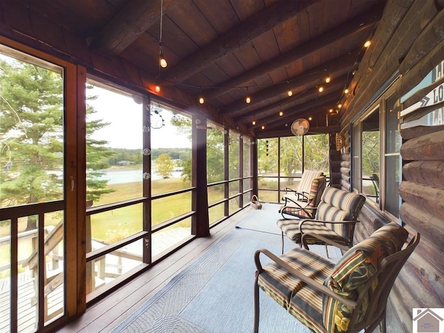 sunroom / solarium with vaulted ceiling with beams, wood ceiling, and a water view