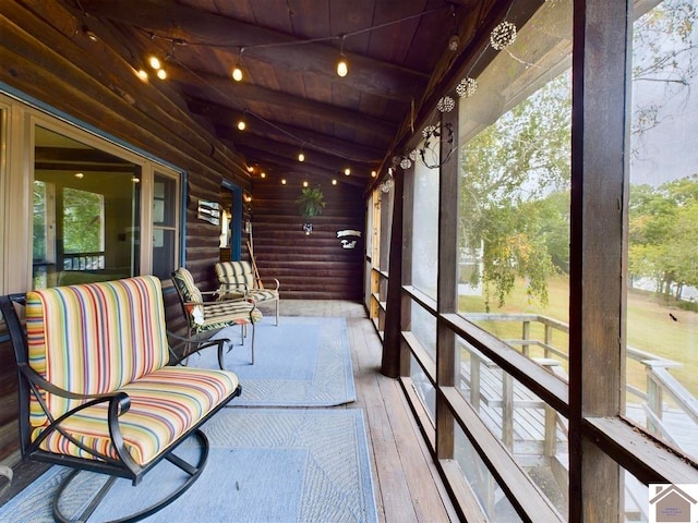 sunroom / solarium featuring wood ceiling and lofted ceiling with beams