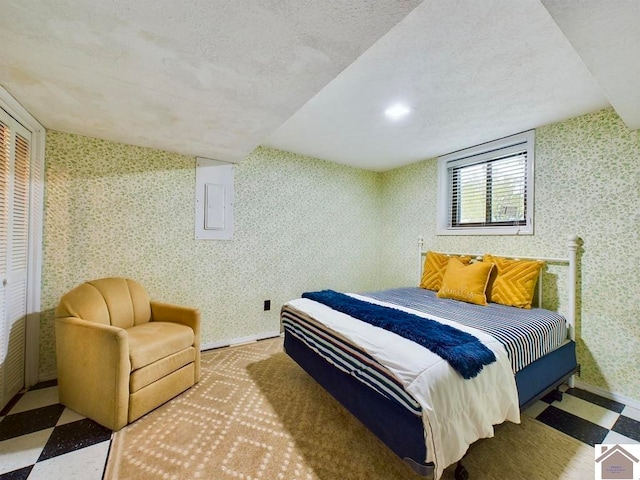 bedroom with a closet, vaulted ceiling, and a textured ceiling