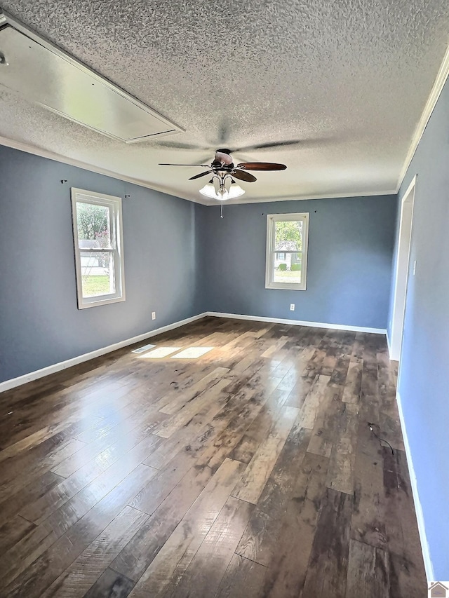 spare room with a textured ceiling, crown molding, dark hardwood / wood-style floors, and ceiling fan