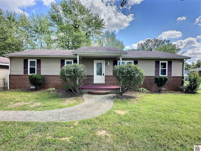 ranch-style home featuring covered porch, a front lawn, and brick siding