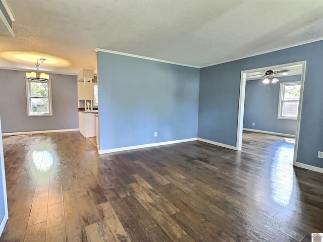 unfurnished room with a textured ceiling, ornamental molding, and dark wood finished floors