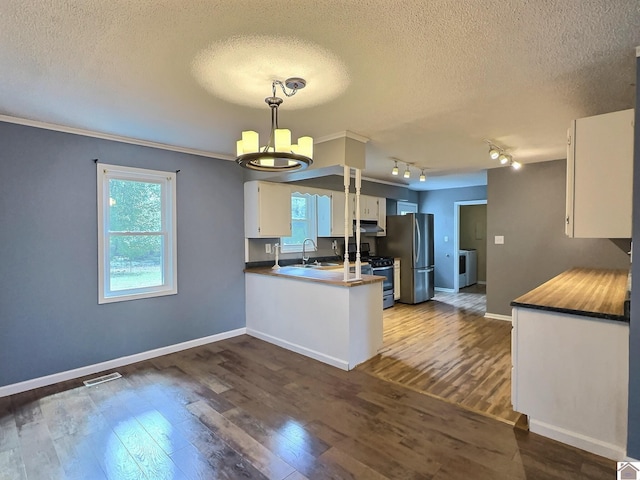 kitchen featuring a textured ceiling, dark wood-type flooring, white cabinetry, kitchen peninsula, and appliances with stainless steel finishes