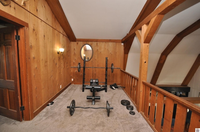 exercise room featuring light carpet, wooden walls, and lofted ceiling