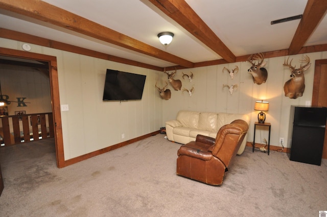 carpeted living room featuring beam ceiling