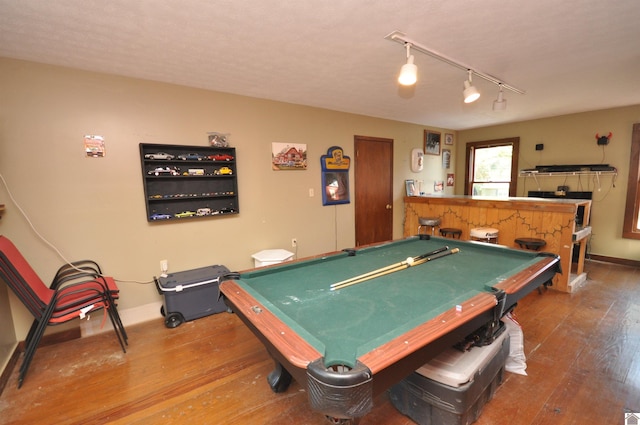 rec room featuring rail lighting, bar area, billiards, and hardwood / wood-style flooring