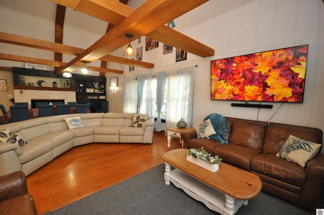 living room featuring beam ceiling and hardwood / wood-style flooring