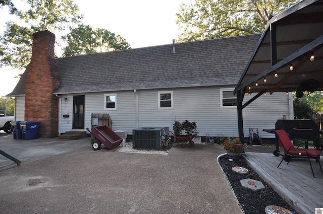 rear view of property with a patio and central AC