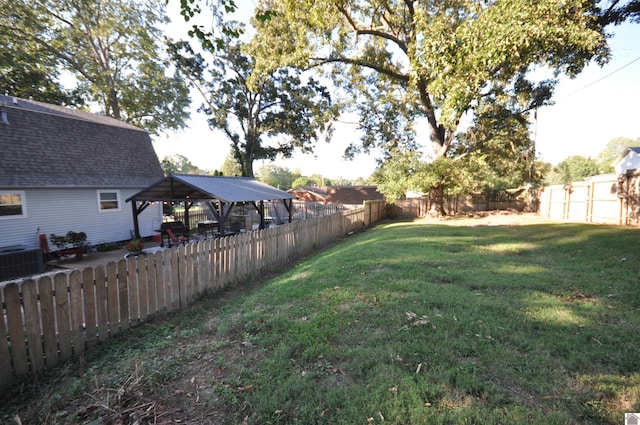 view of yard with central AC unit and a gazebo