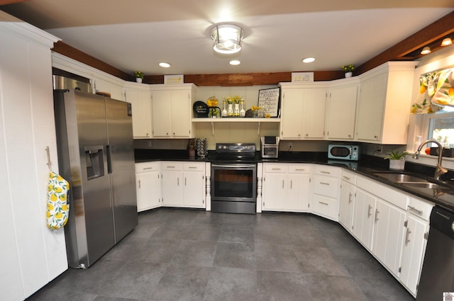 kitchen featuring white cabinets, appliances with stainless steel finishes, and sink