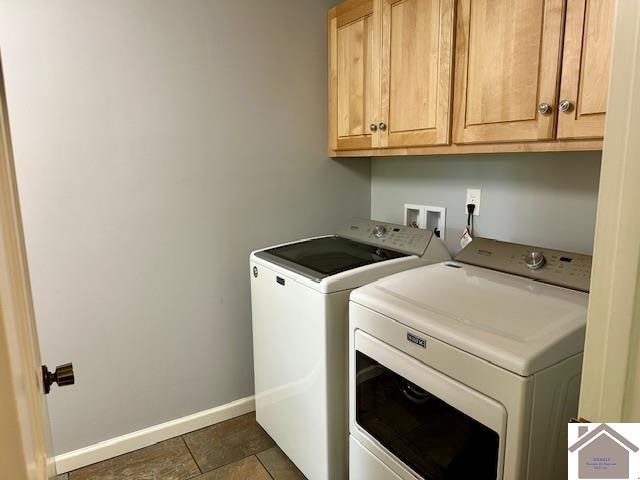 laundry room featuring washer and dryer and cabinets