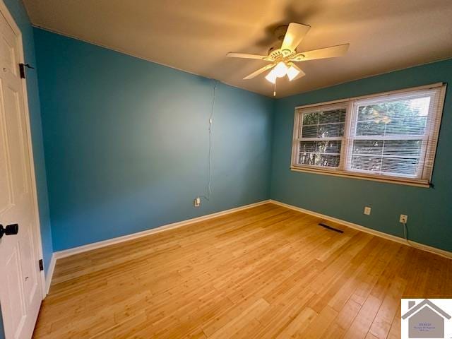 spare room with light hardwood / wood-style floors and ceiling fan