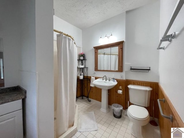 bathroom with walk in shower, a textured ceiling, wooden walls, and toilet