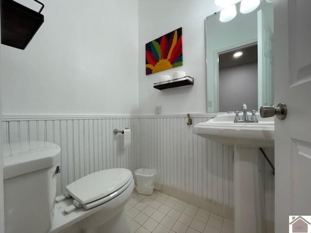 bathroom with sink, toilet, and tile patterned floors