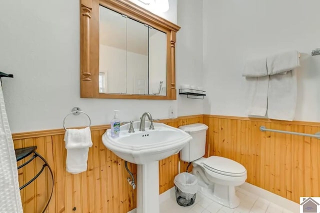 354 Sassafrass Rd, Cadiz, KY 42211 - half bathroom featuring wainscoting, wooden walls, toilet, and tile patterned flooring