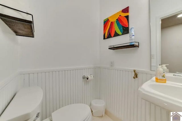 354 Sassafrass Rd, Cadiz, KY 42211 - bathroom with toilet, wainscoting, and a decorative wall
