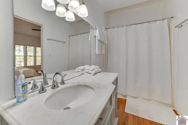 354 Sassafrass Rd, Cadiz, KY 42211 - full bathroom with a chandelier, wood finished floors, vanity, and curtained shower