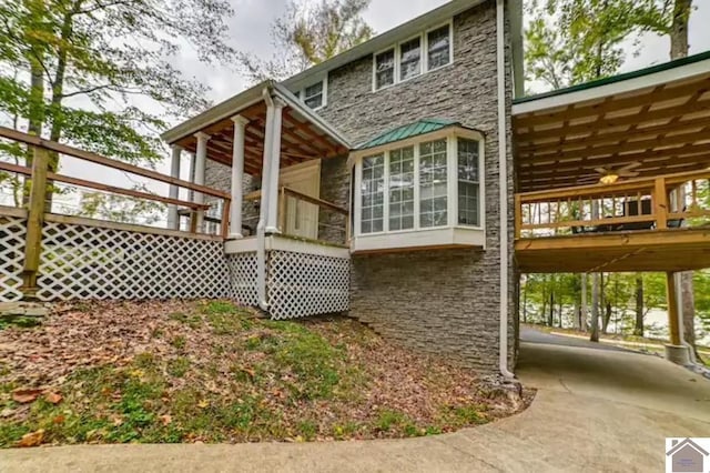 354 Sassafrass Rd, Cadiz, KY 42211 - rear view of house with stone siding, ceiling fan, a carport, and a deck