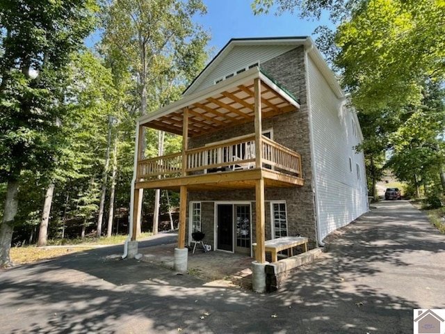 back of house featuring a deck