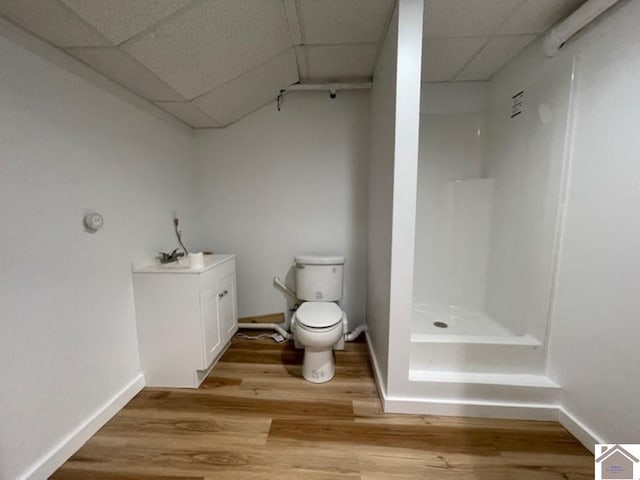 354 Sassafrass Rd, Cadiz, KY 42211 - bathroom with a shower, a paneled ceiling, toilet, wood finished floors, and baseboards