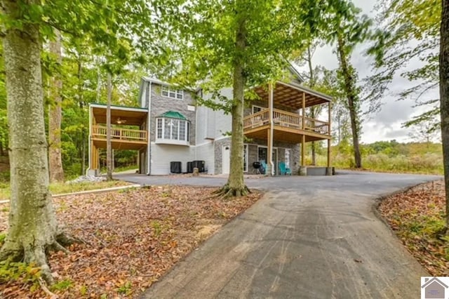 354 Sassafrass Rd, Cadiz, KY 42211 - back of house featuring driveway, stone siding, and a deck