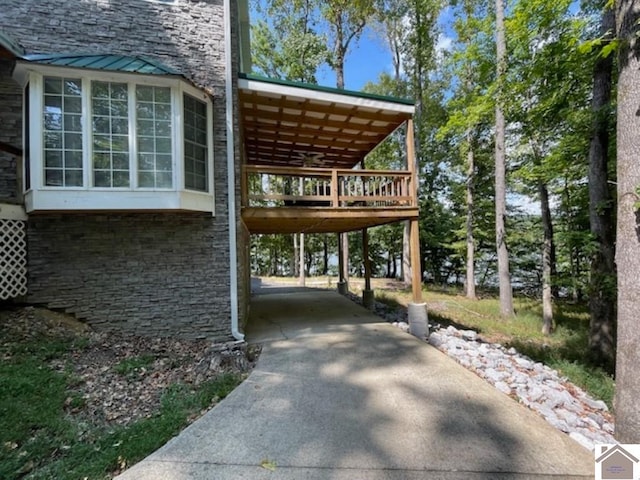 view of side of home with a carport and a deck