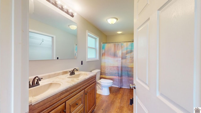 bathroom featuring hardwood / wood-style floors, vanity, toilet, and a shower with curtain