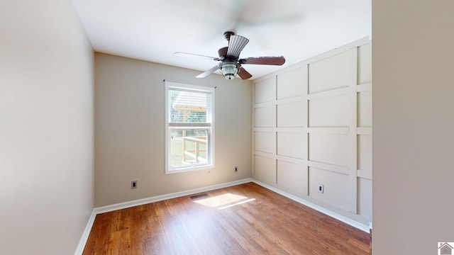 spare room featuring hardwood / wood-style floors and ceiling fan