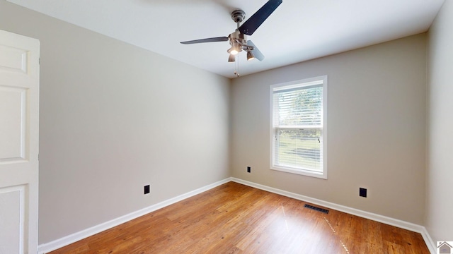 unfurnished room with ceiling fan and light wood-type flooring