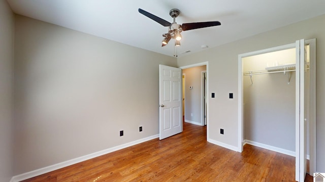 unfurnished bedroom with ceiling fan, light hardwood / wood-style floors, and a closet